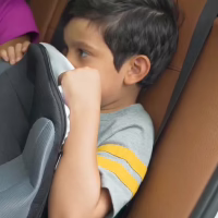 Young boy sitting on his BubaBoost booster in his grandparents' car